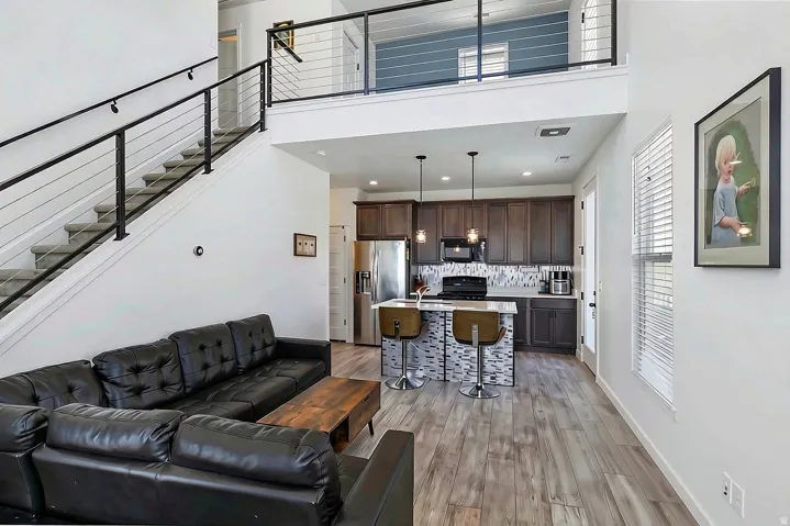 Open-concept living space with wood-finish flooring
