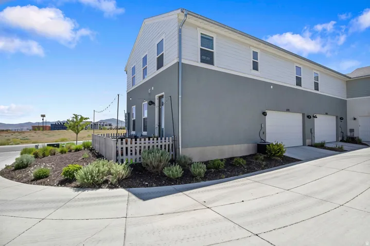 View od side yard/fenced in patio and 2 car attached garage