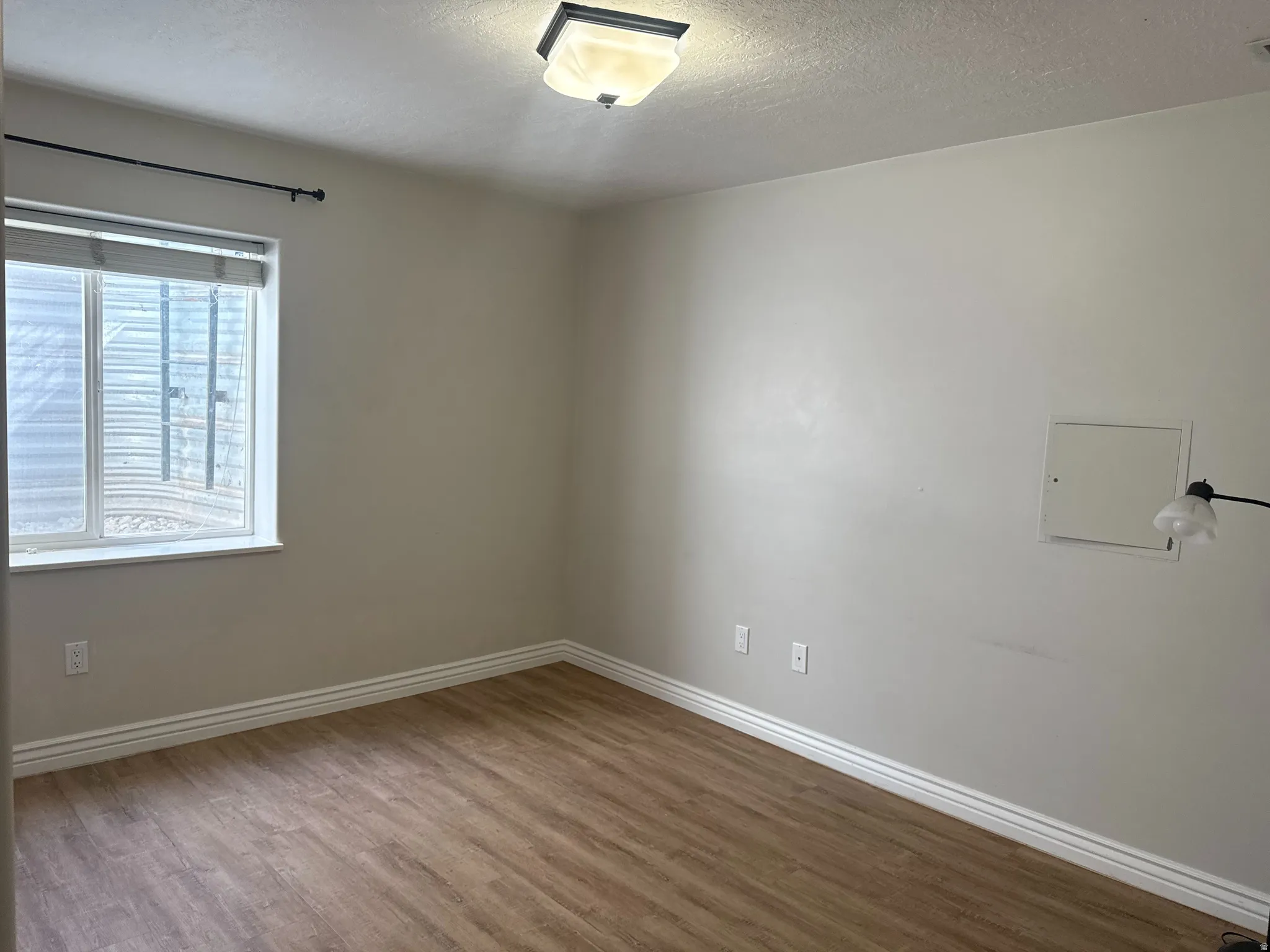 Neutral-toned walls complement wood-finish flooring