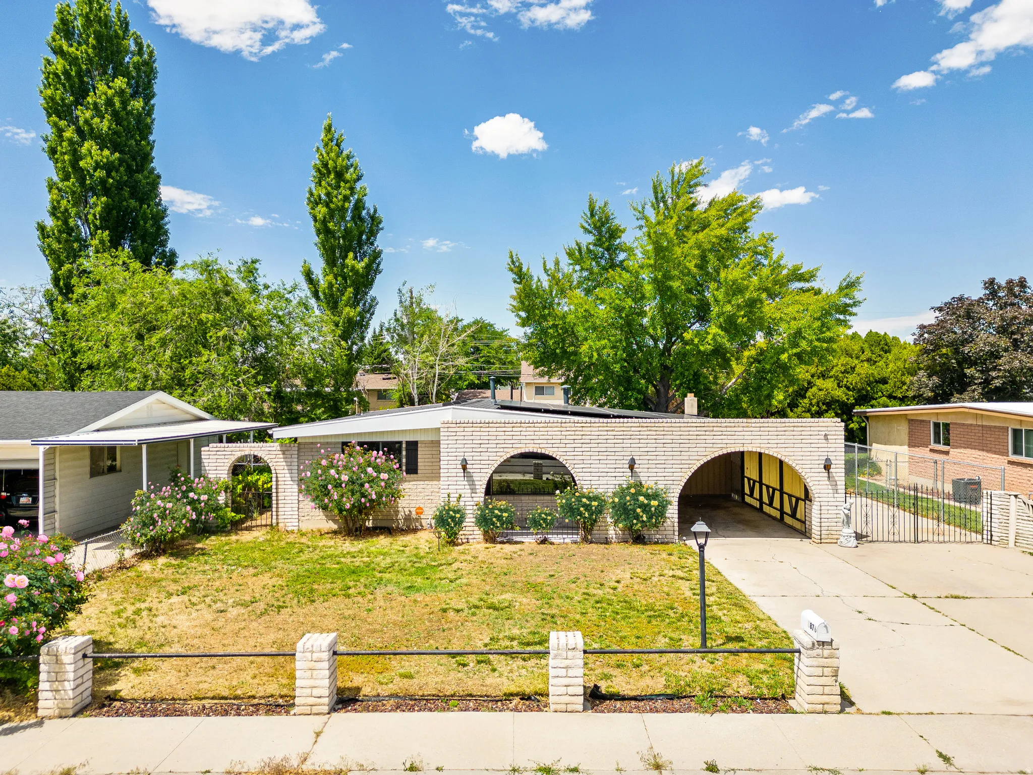 Single-story residence featuring a light brick exterior with multiple archways