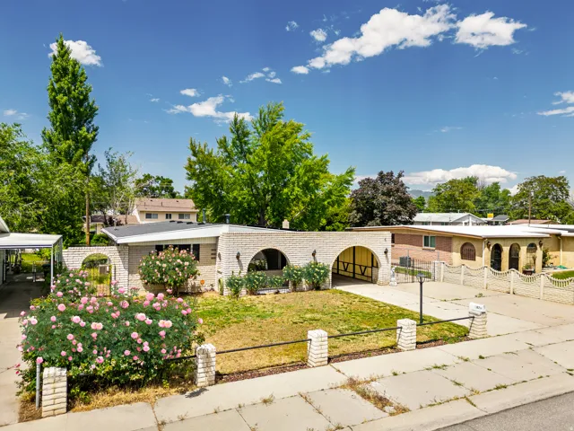 Mediterranean-inspired exterior with archway details and a flat roofline