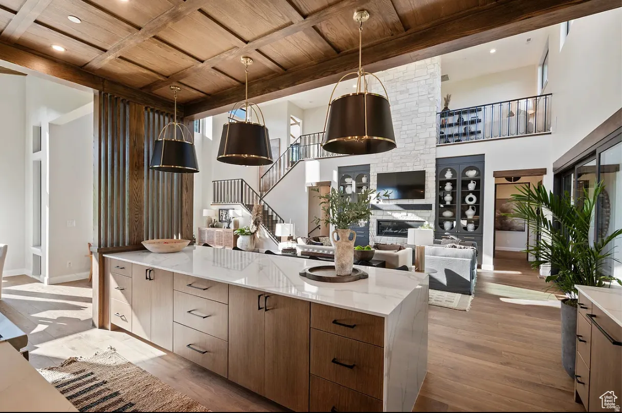 Expansive open-concept interior featuring a coffered wood ceiling and wood-finish flooring