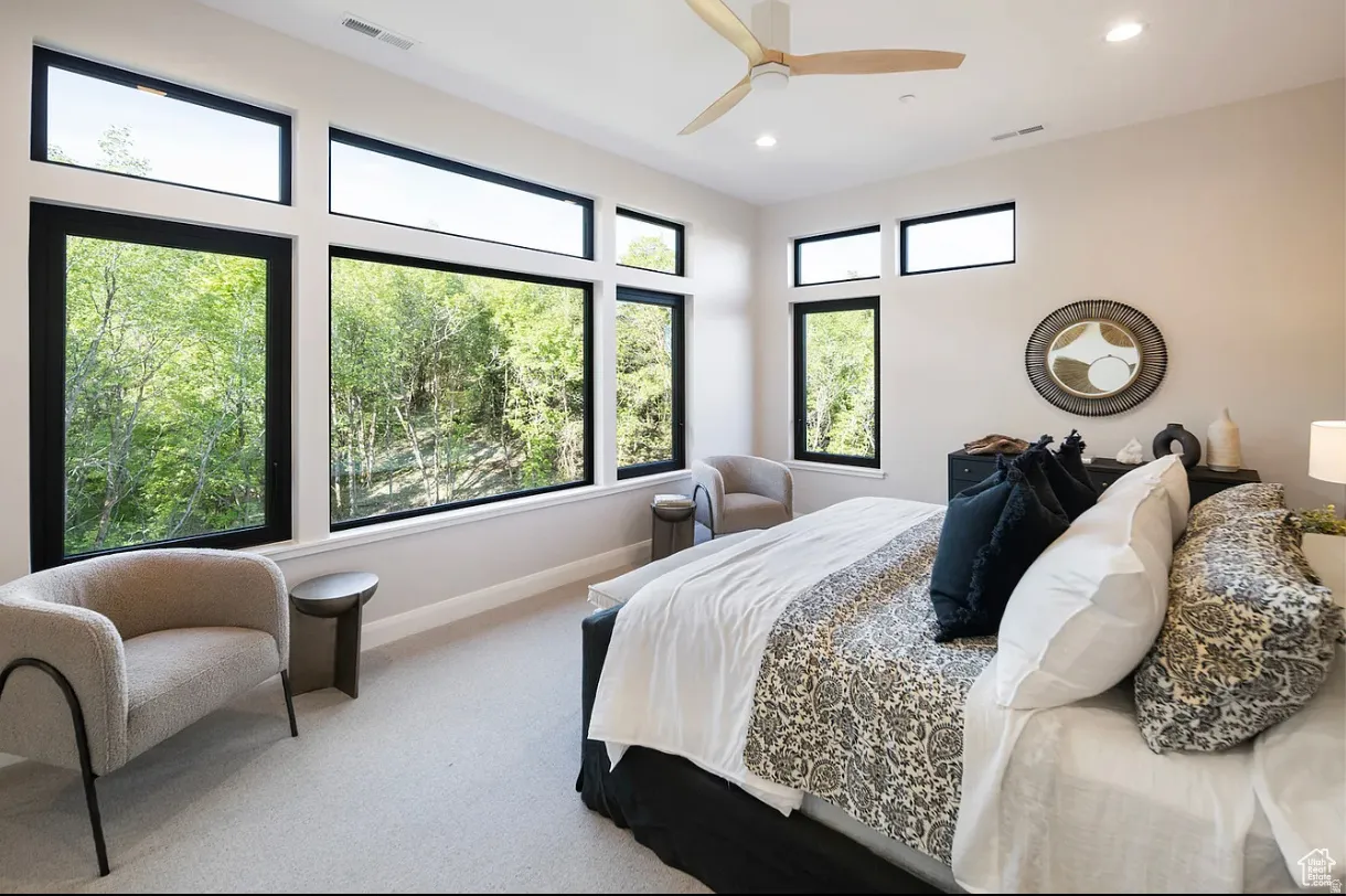 Expansive window wall with black frames, offering abundant natural light