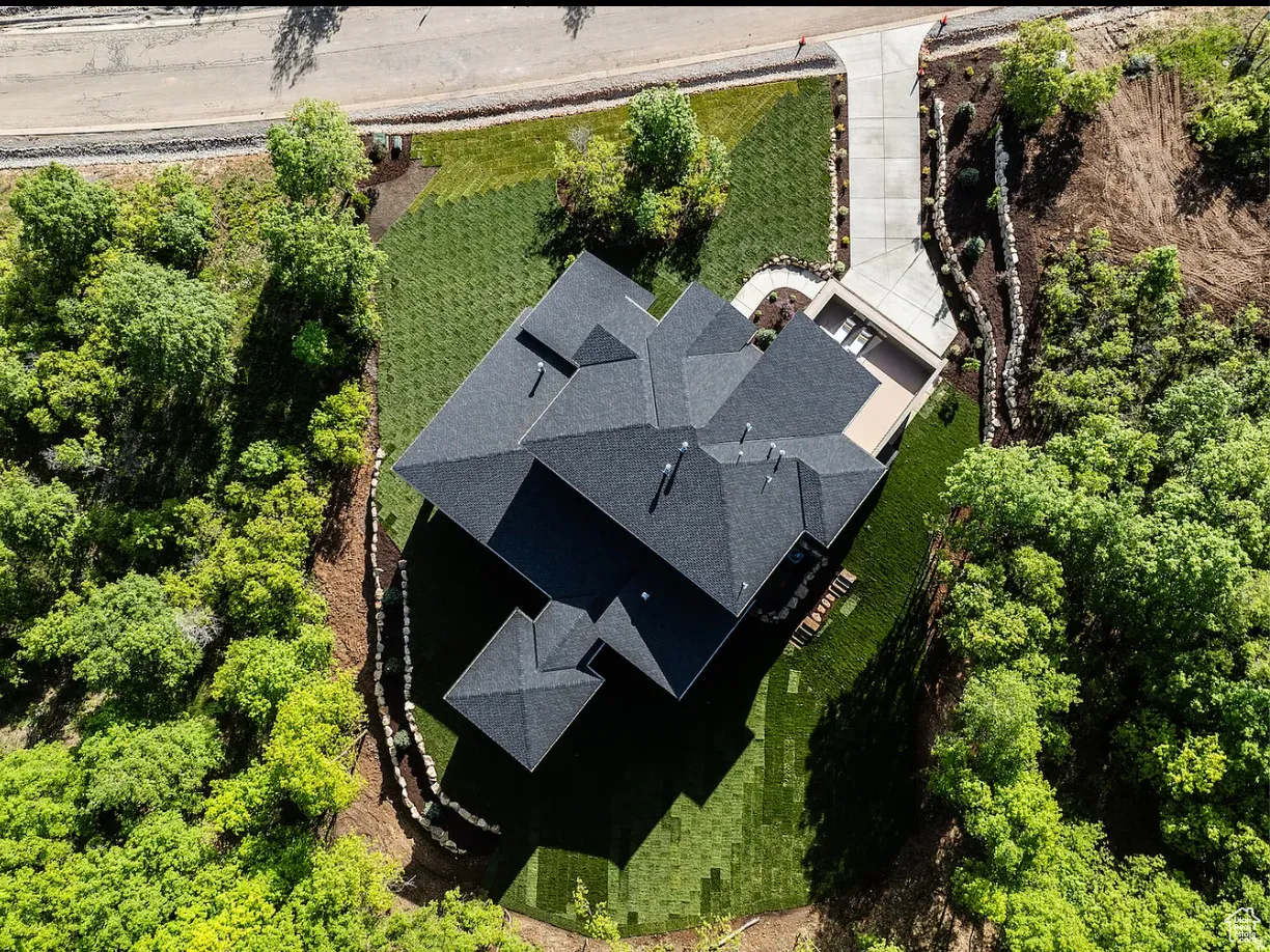 Newly constructed residence featuring a multi-gabled asphalt shingle roof