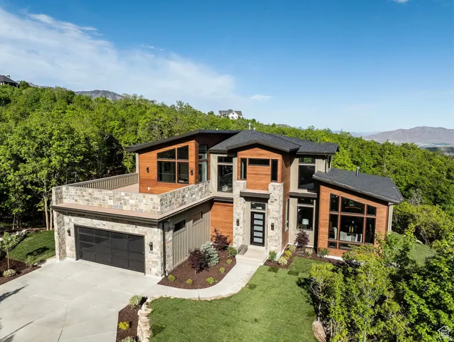 Contemporary exterior with stone veneer and wood-finish siding