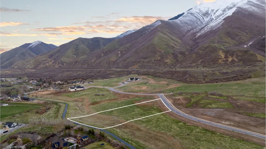 Expansive lot offering mountain backdrops and a paved road frontage