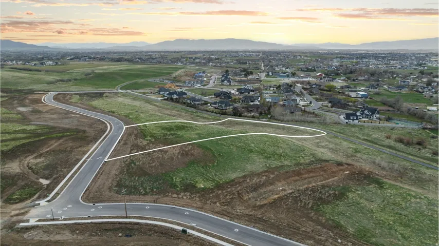 Expansive green space with defined property boundaries, offering a clear development opportunity