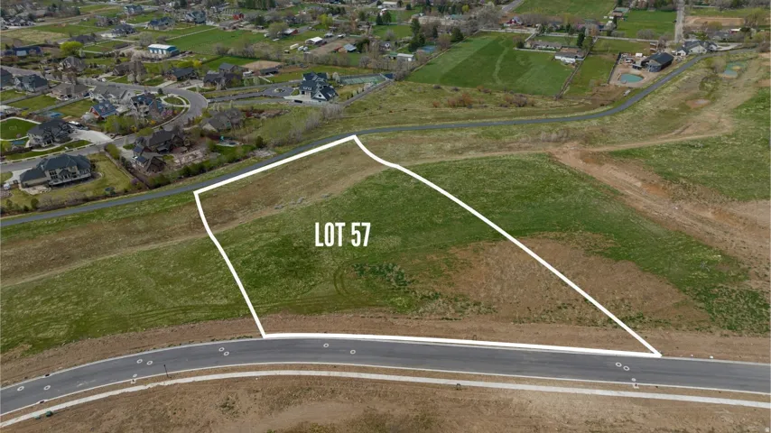 Aerial depiction of Lot 57, featuring a graded build site with partial green ground cover and direct road frontage