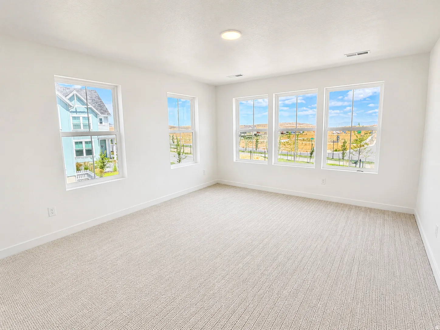 Primary bedroom with large walk in closet and ensuite bathroom. Large windows with mountain views.