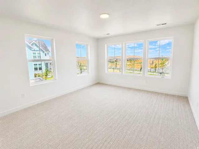 Primary bedroom with large walk in closet and ensuite bathroom. Large windows with mountain views.