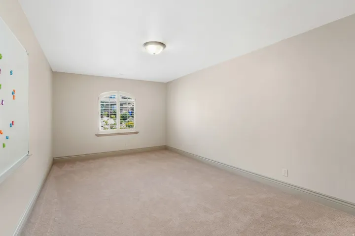 Light beige carpeting extending throughout the room