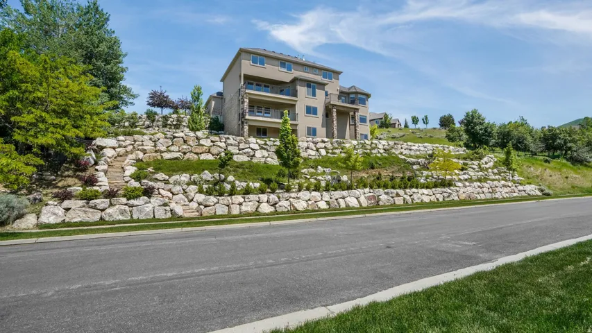 Multi-level residence featuring a stucco exterior and multiple balconies