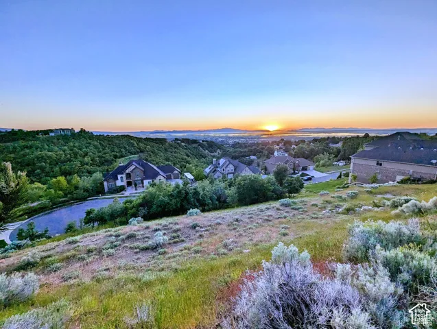 Expansive hillside property with distant water and mountain scenery