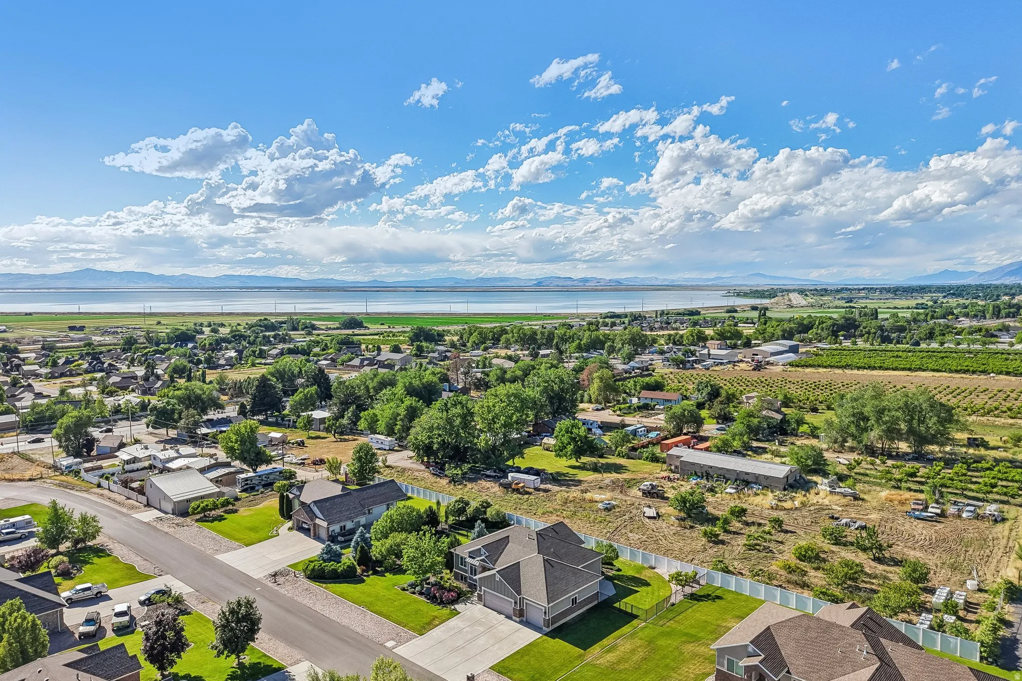 Aerial perspective showcasing residential properties with a mountainous and water backdrop