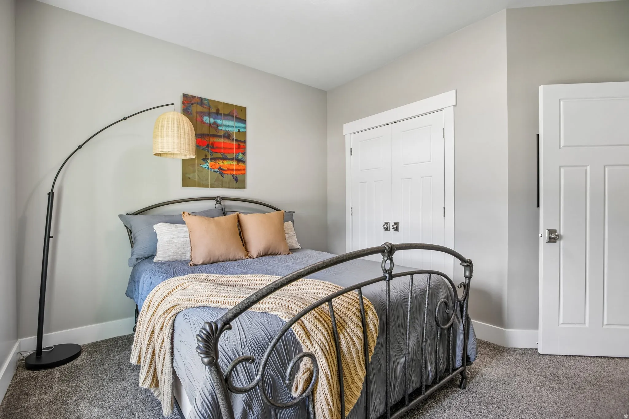 Bedroom 2 - Light wall color, white trim, and light brown textured carpeting and large closet