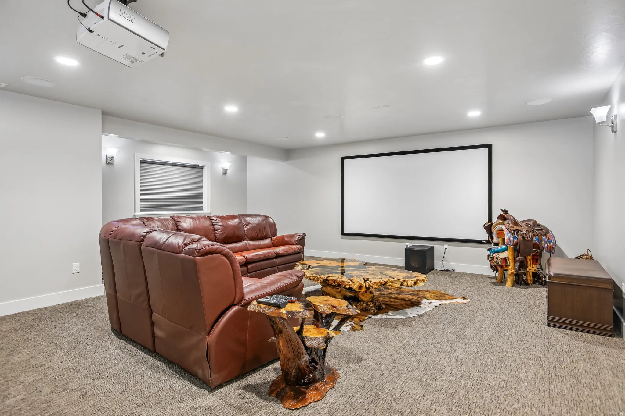 Dedicated media room featuring a large projection screen, recessed ceiling lighting, and  adjustable wall sconces, black out cellular blinds.  All media equipment is included