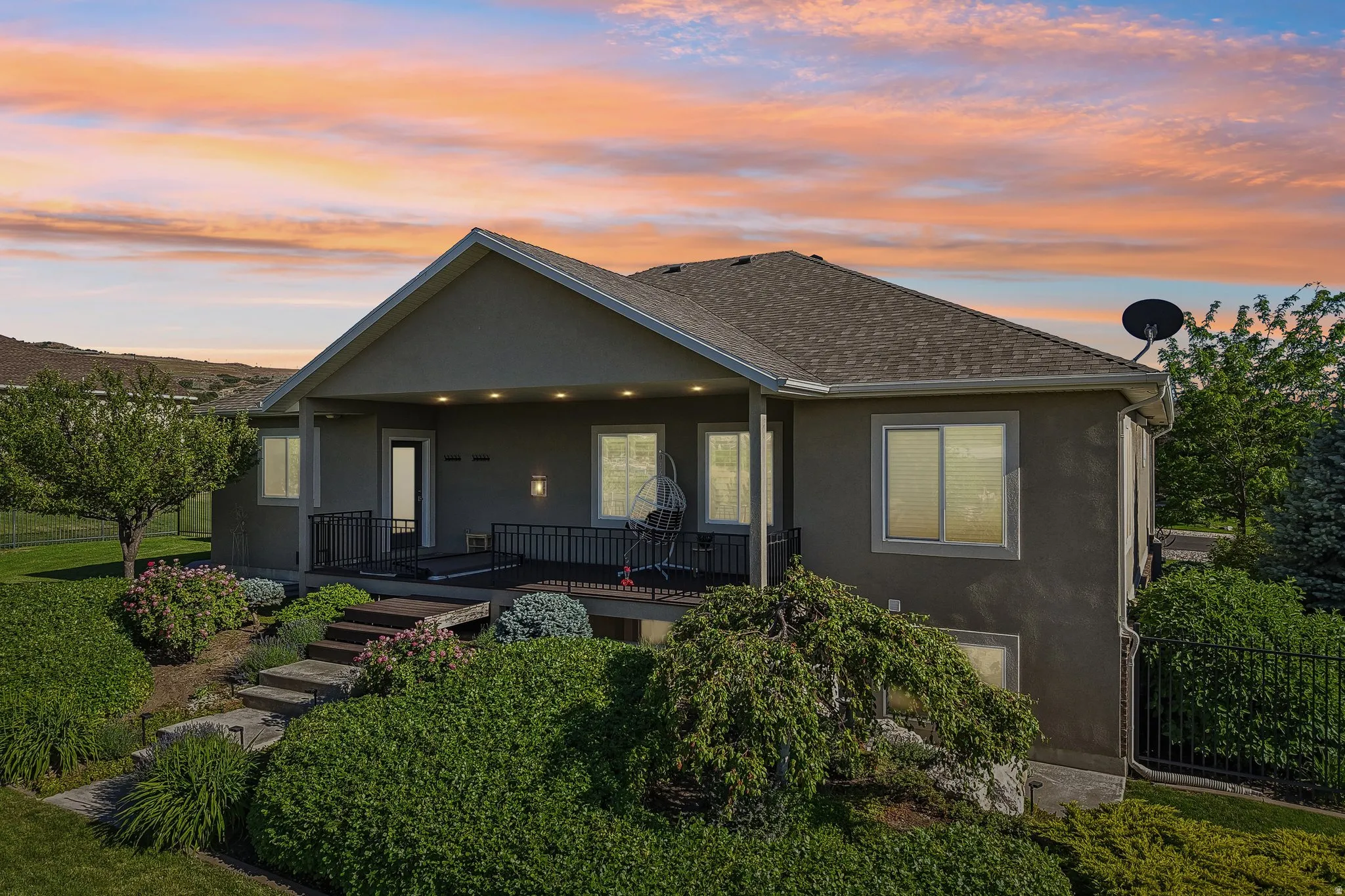 Stucco exterior with a covered patio, recessed lighting, and a dark metal railing, you will definitely enjoy those gorgeous evening sunsets