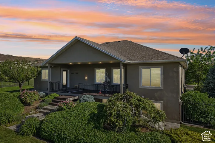 Stucco exterior with a covered patio, recessed lighting, and a dark metal railing, you will definitely enjoy those gorgeous evening sunsets