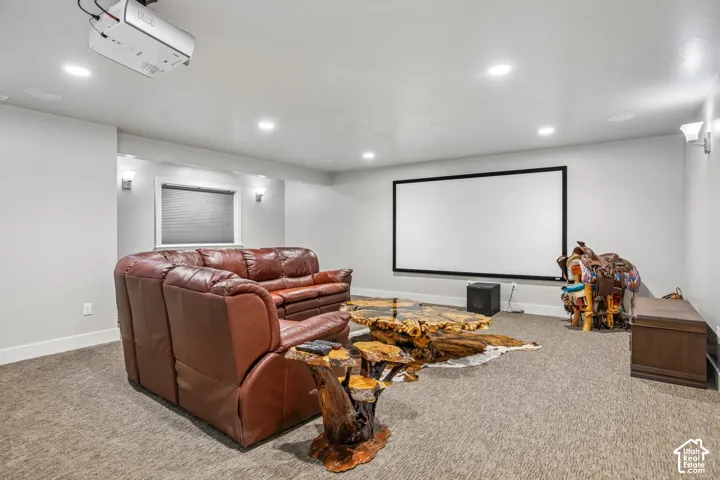 Dedicated media room featuring a large projection screen, recessed ceiling lighting, and  adjustable wall sconces, black out cellular blinds.  All media equipment is included