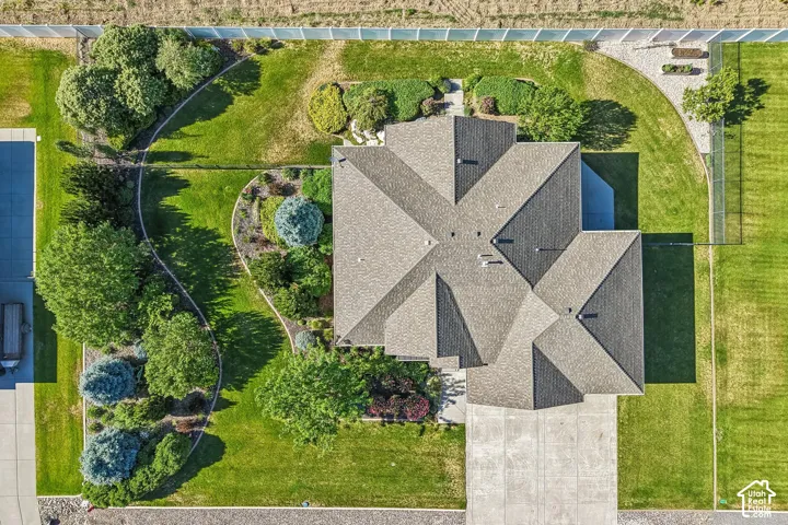 Aerial view highlighting the property's roofline and expansive green spaces