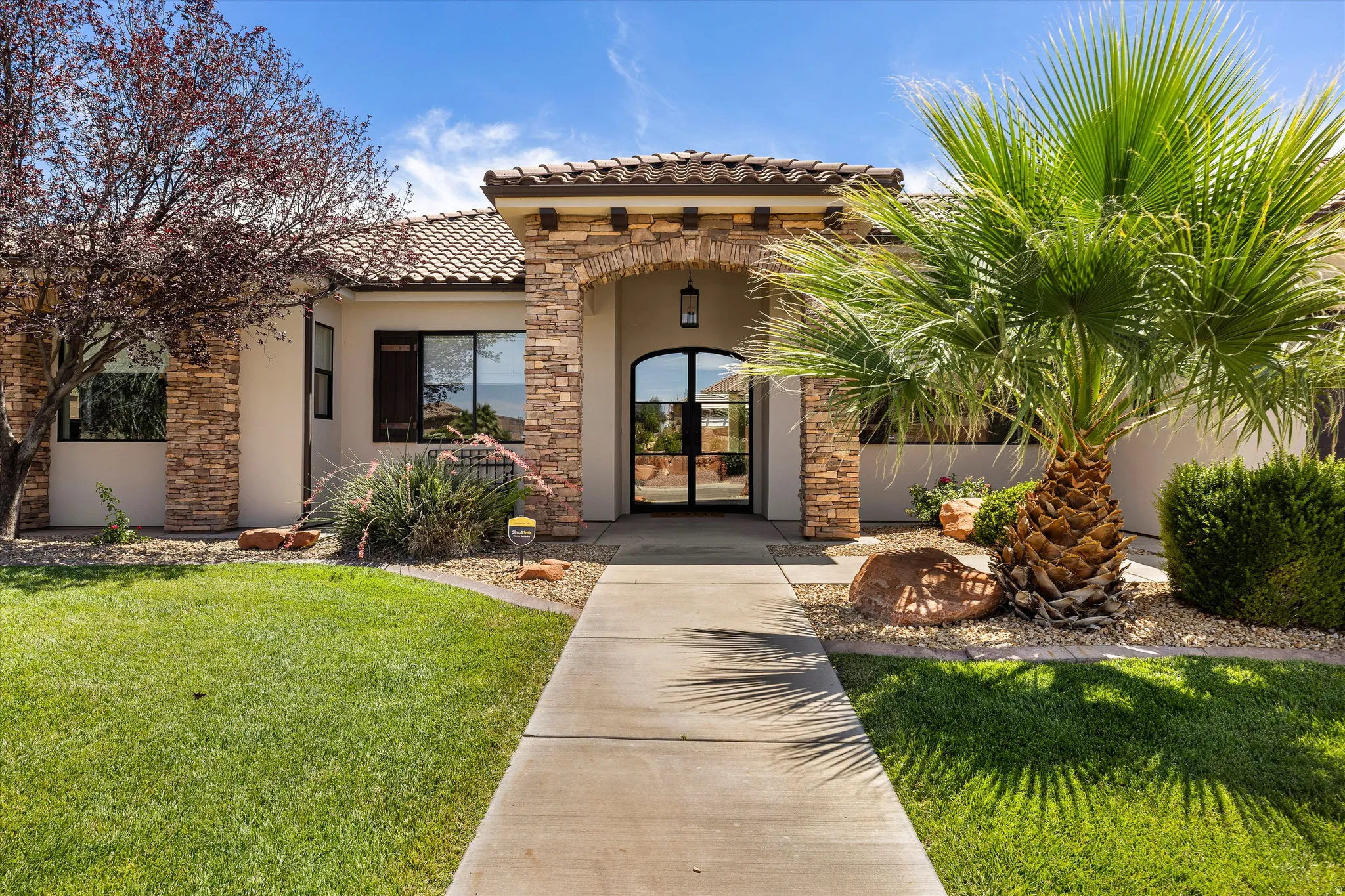 Stucco exterior with stone accents and a tile roof