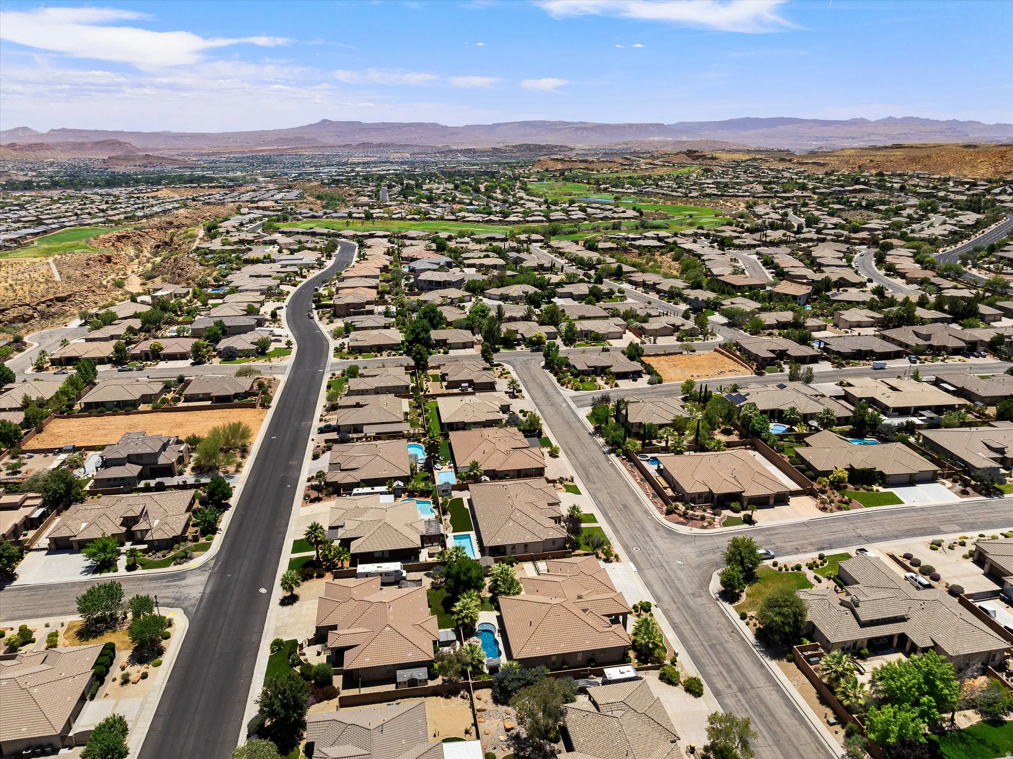 Sprawling residential community featuring a variety of single-story homes with tile roofs