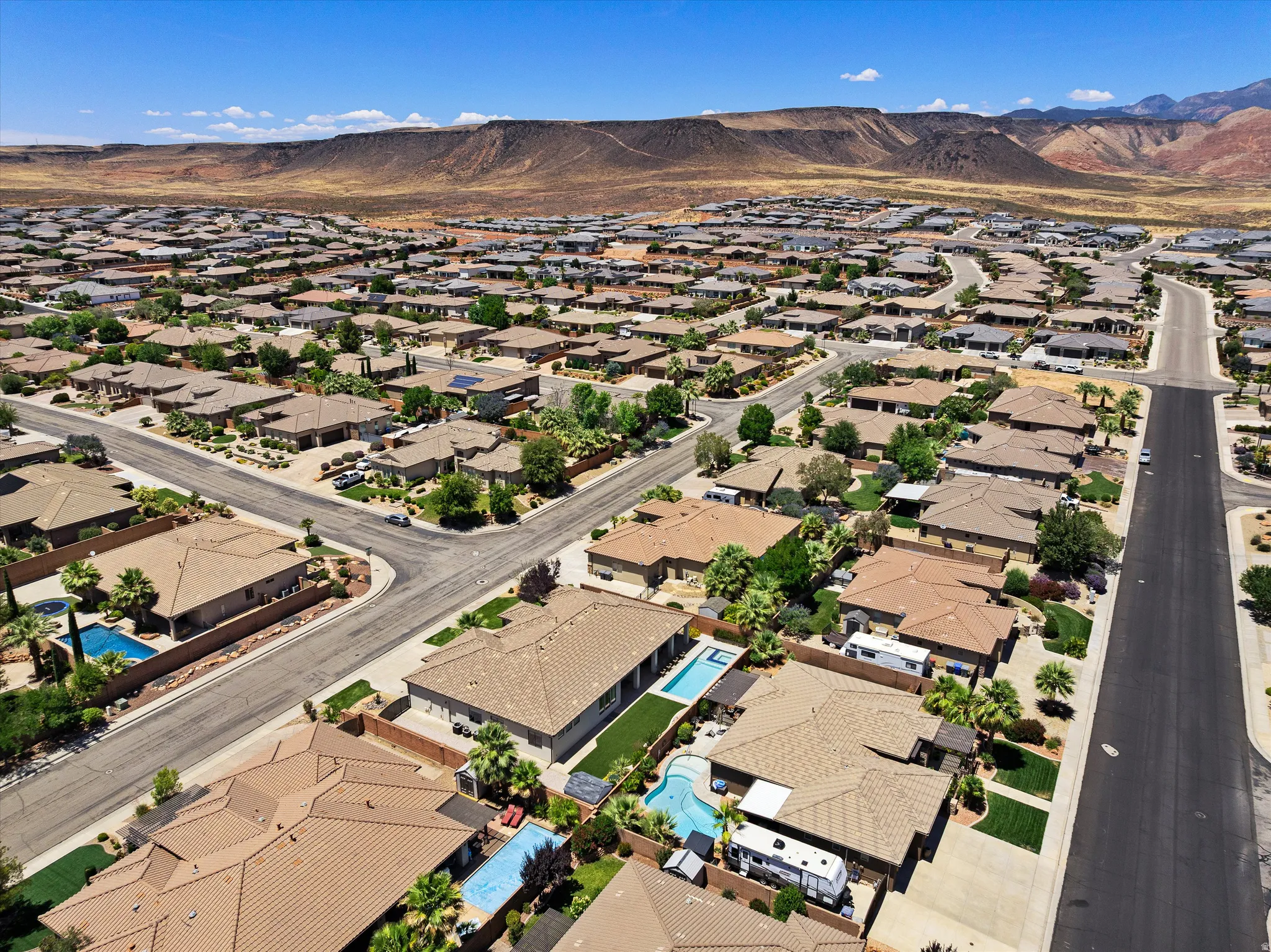 Expansive residential community with varied rooflines and a mountainous backdrop