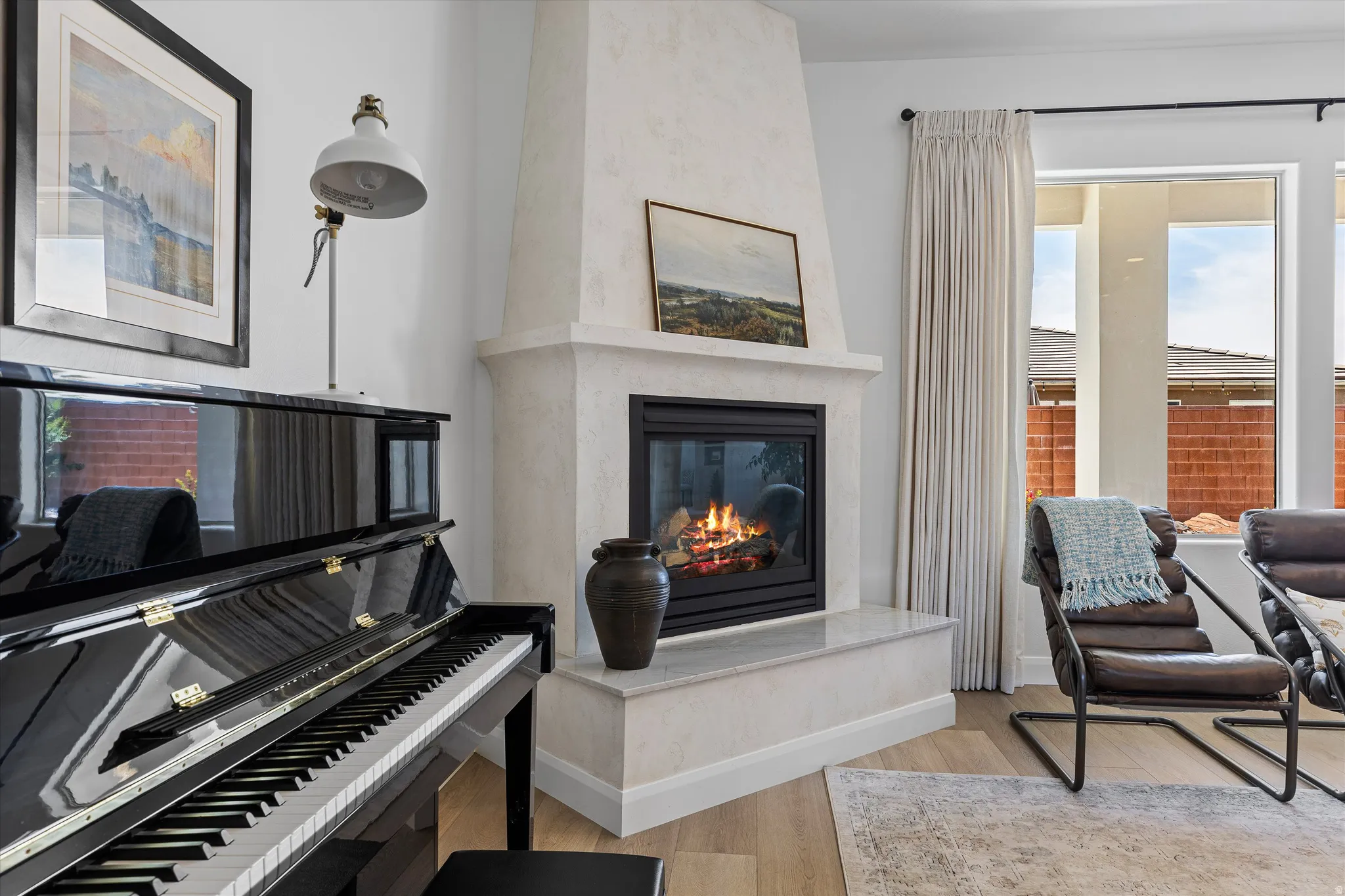 Living area featuring a floor-to-ceiling fireplace with a marble hearth and a black framed firebox
