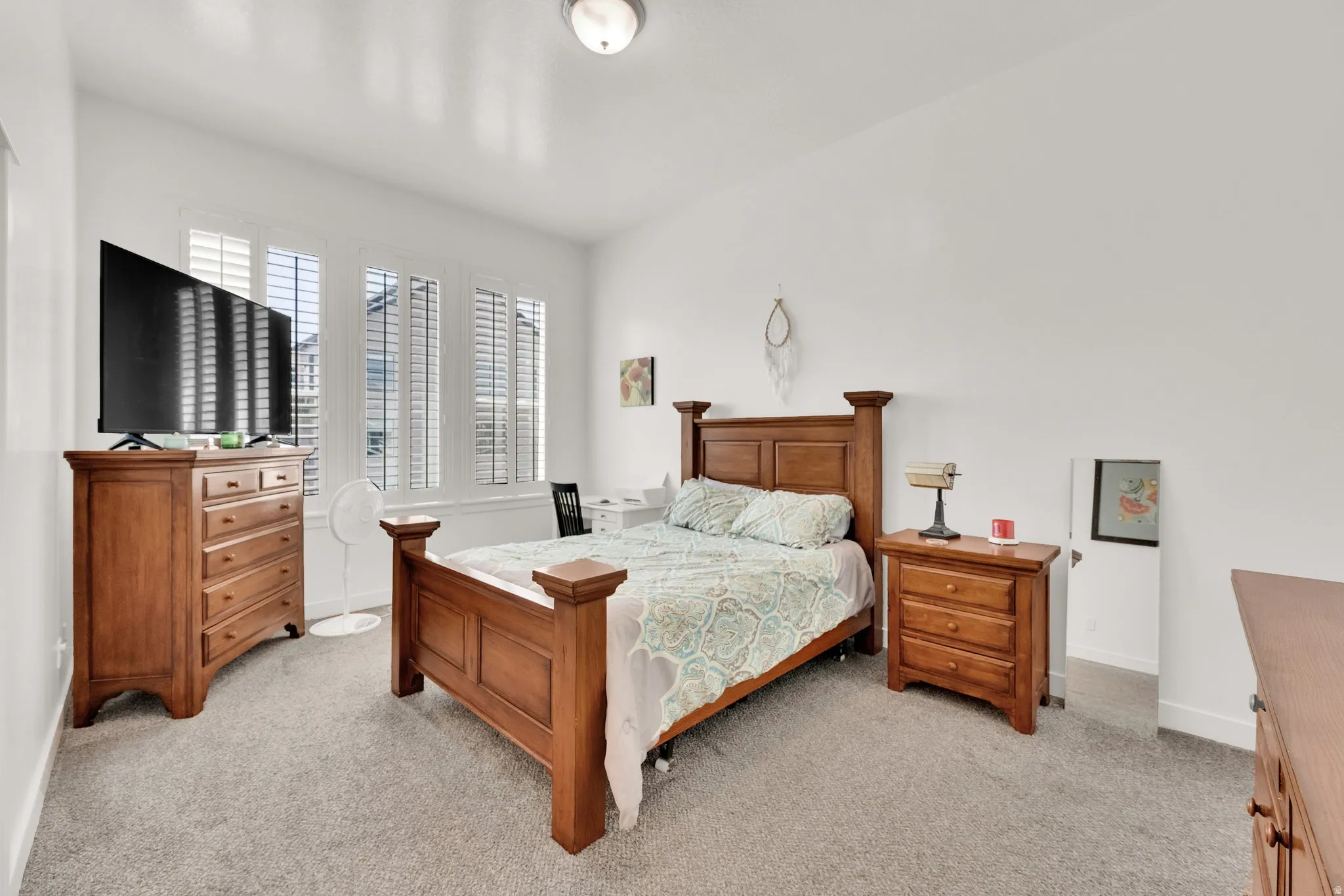 Bedroom with light gray carpeting and white walls