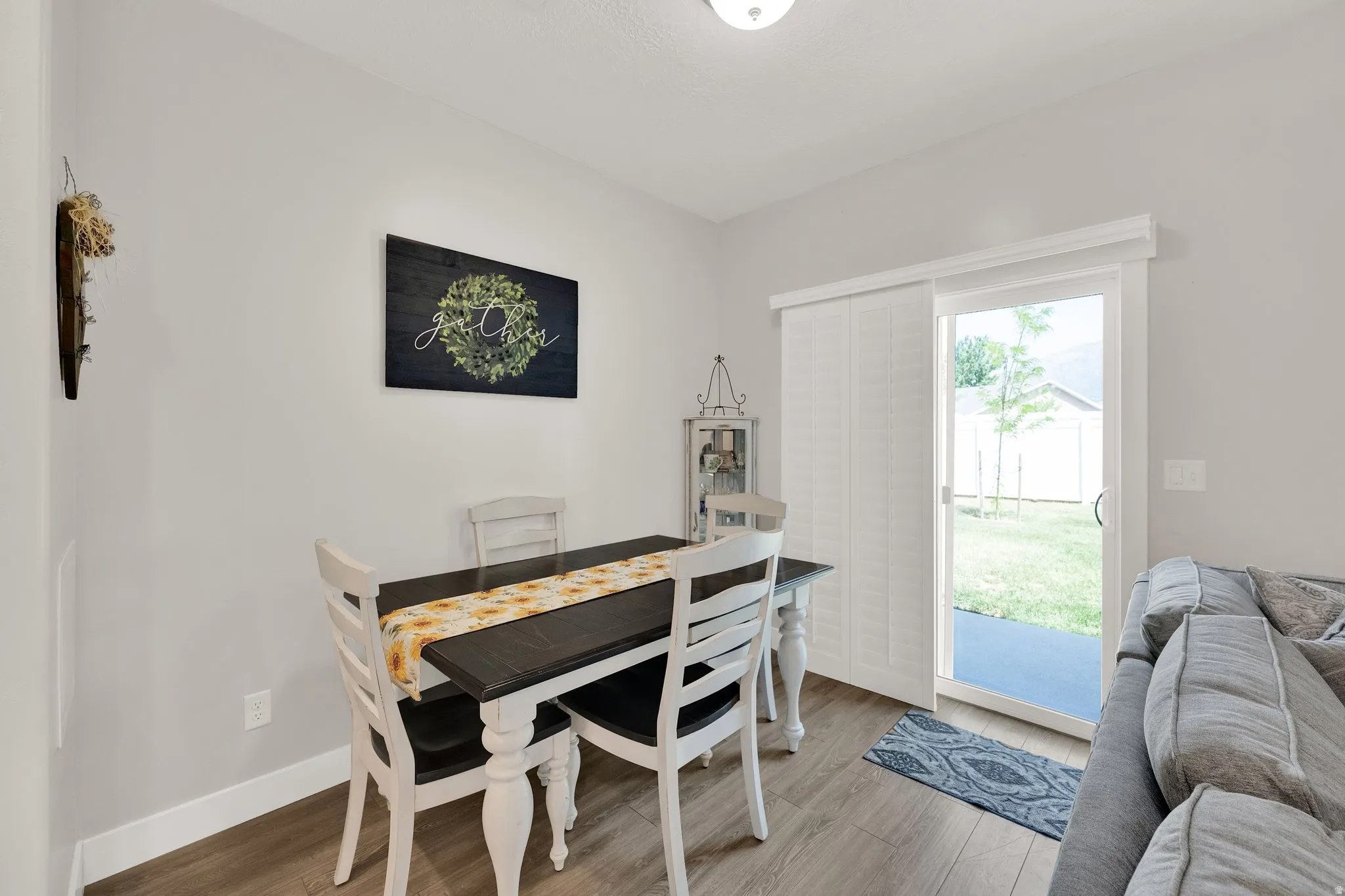 Dining area featuring wood-finish flooring and light gray wall paint