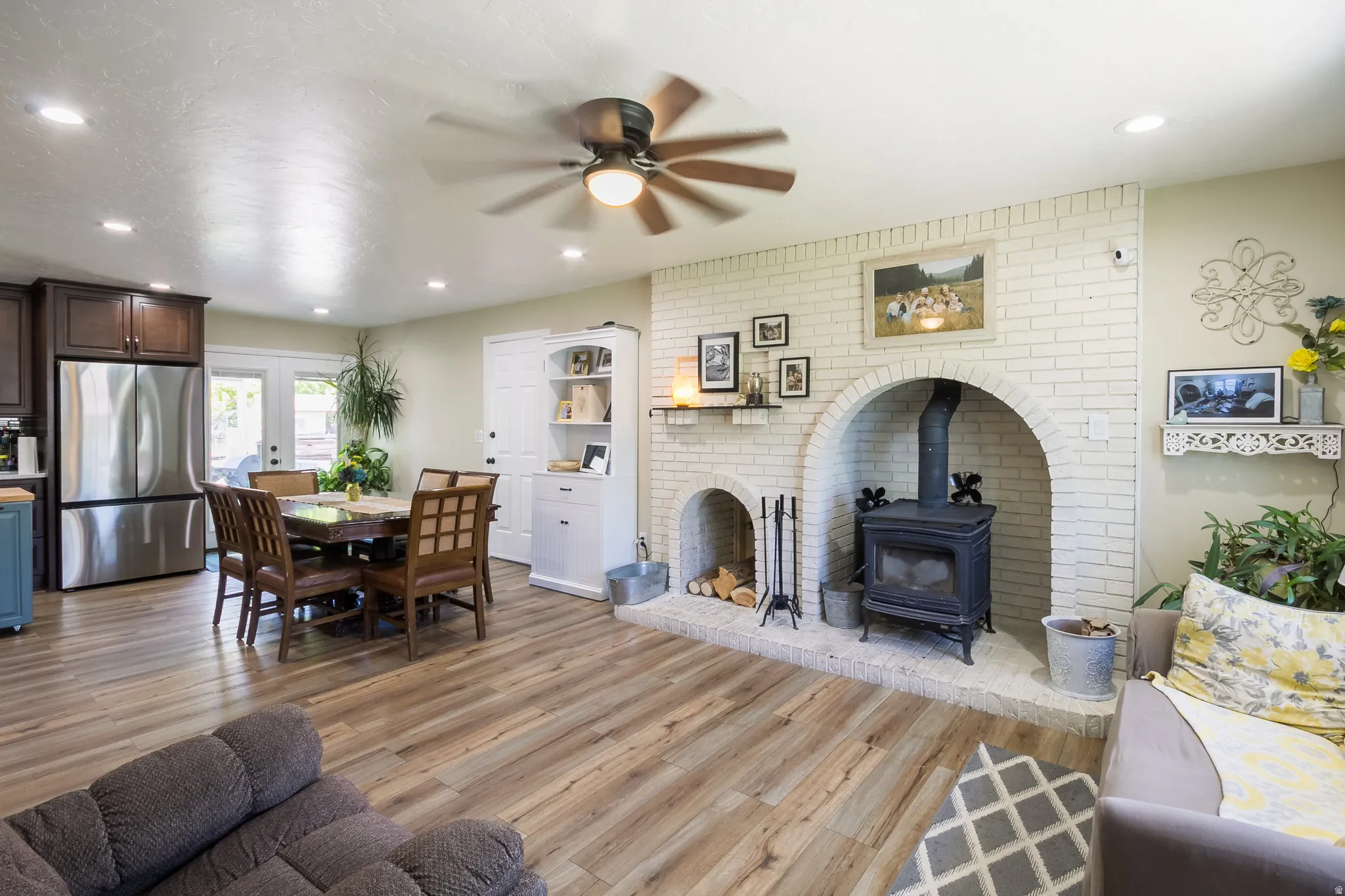 Spacious open-concept living area featuring wood-finish flooring, recessed lighting, and a ceiling fan