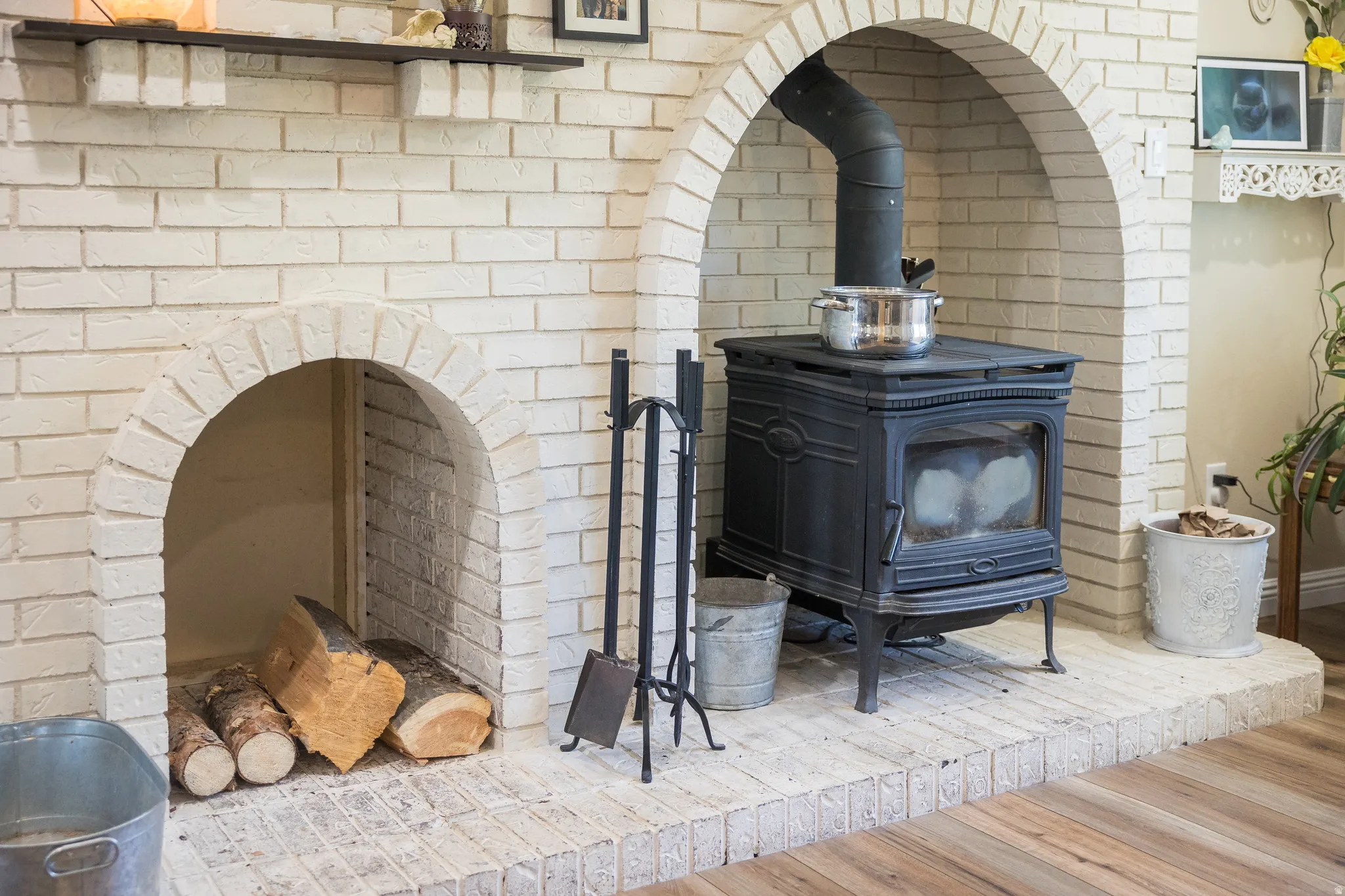 Painted brick fireplace feature with two arched openings