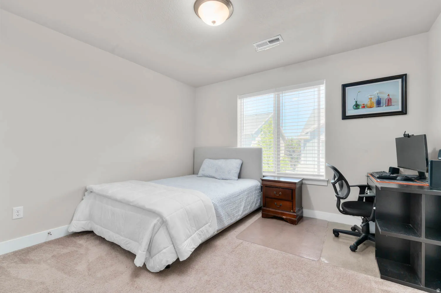 Carpeted room featuring a single window with horizontal blinds, a ceiling-mounted light fixture, and light-toned walls