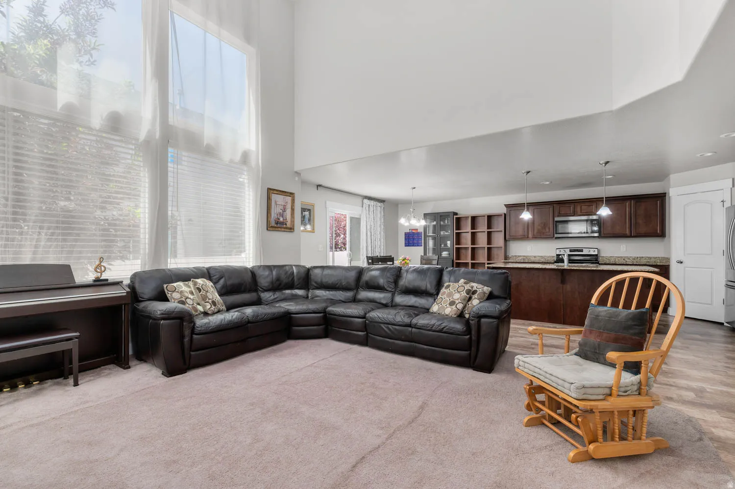 Open-concept living area with a two-story ceiling and large windows