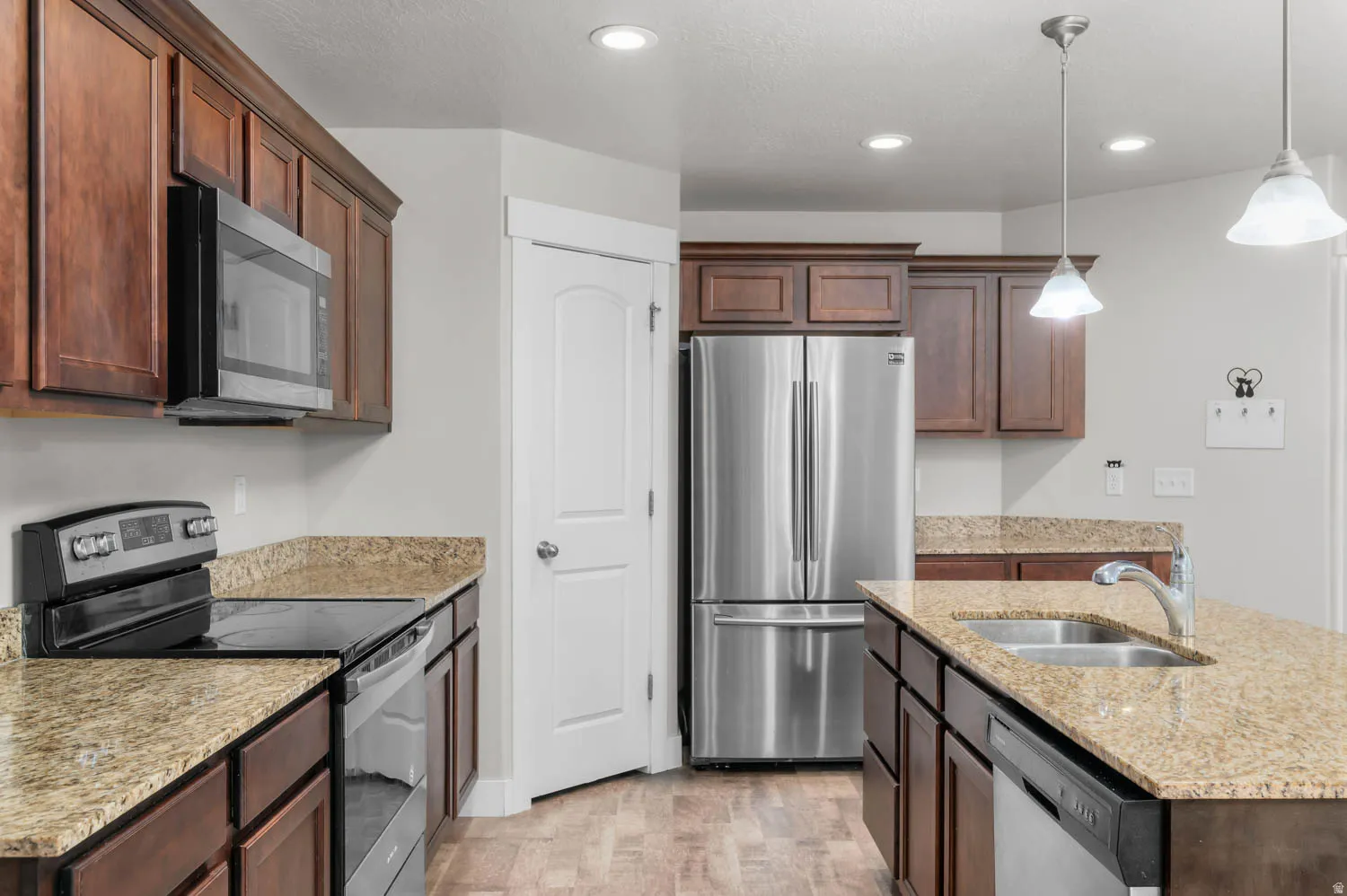 Kitchen featuring wood-finish cabinetry and light-toned countertops