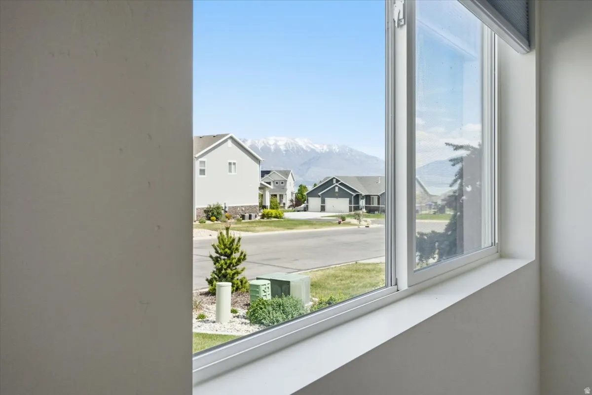Double-pane window featuring a wide sill and a mountain backdrop