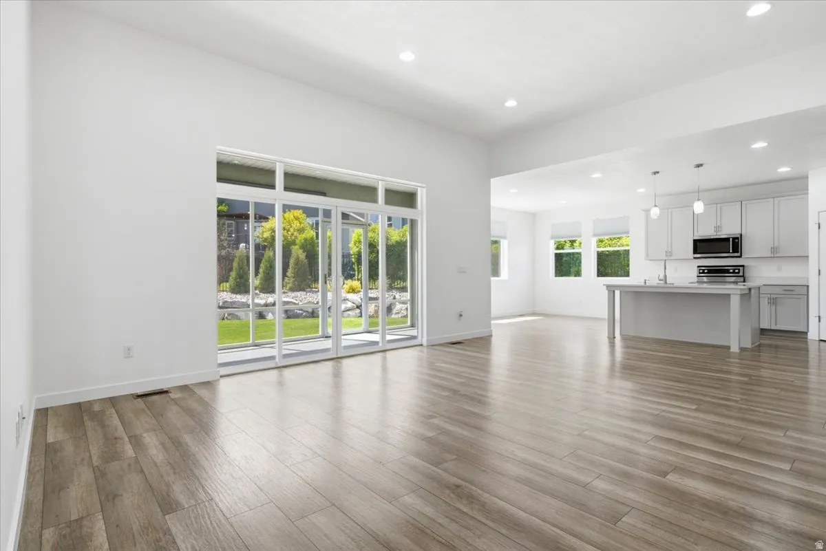Bright interior space featuring wood-finish flooring, recessed lighting, and white walls