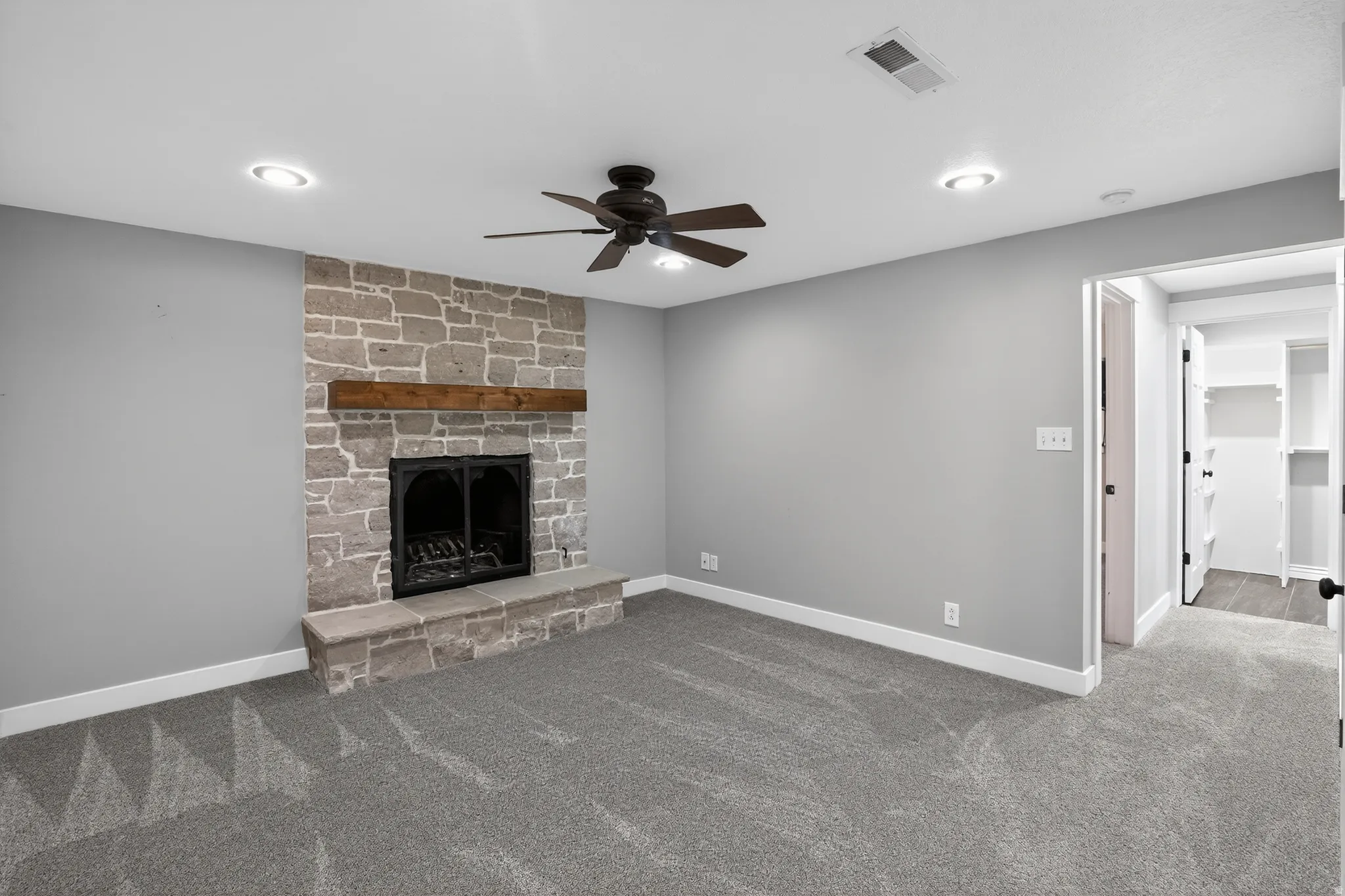 Stone-faced fireplace with a wood mantel