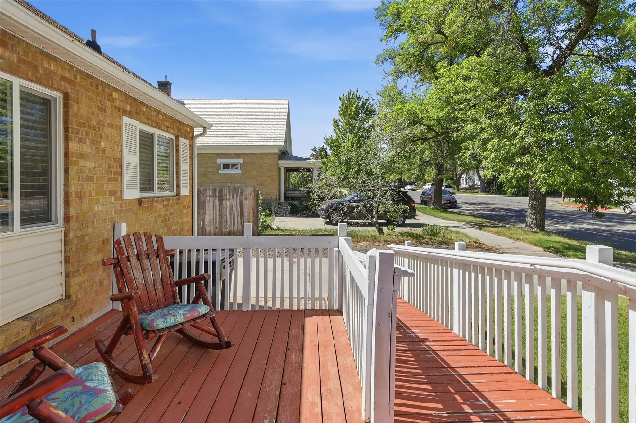 Exterior wood deck and ramp featuring white railings