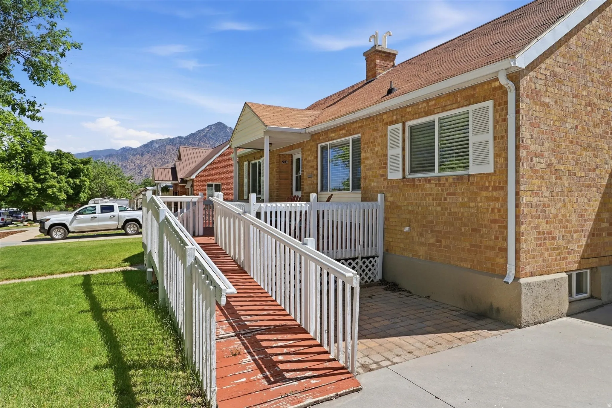 Brick-clad exterior with white trim and shutters