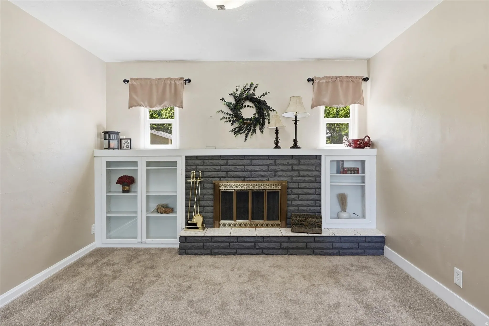 Central fireplace with a dark gray brick surround and a white mantel