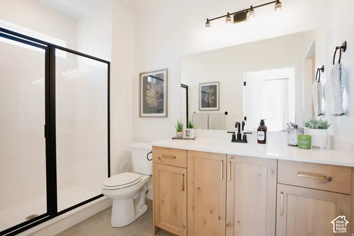 Bathroom featuring a spacious shower with black-framed glass enclosure, white shower pan, and light-toned floor tile
