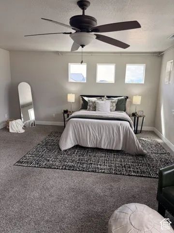 Recessed lighting, ceiling fan with integrated light, three square windows, and neutral wall tones