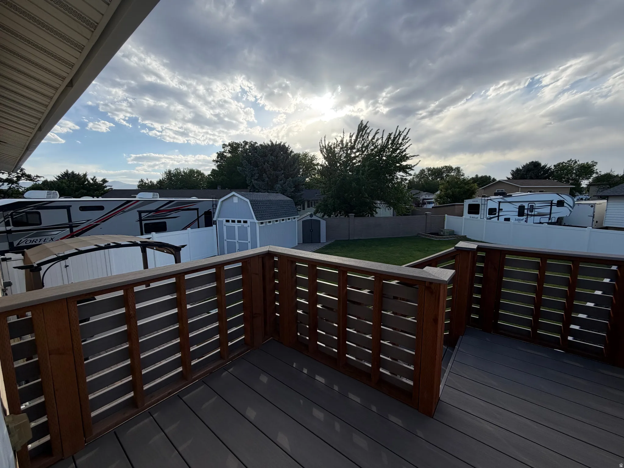 Expansive deck featuring composite decking and horizontal wooden railings