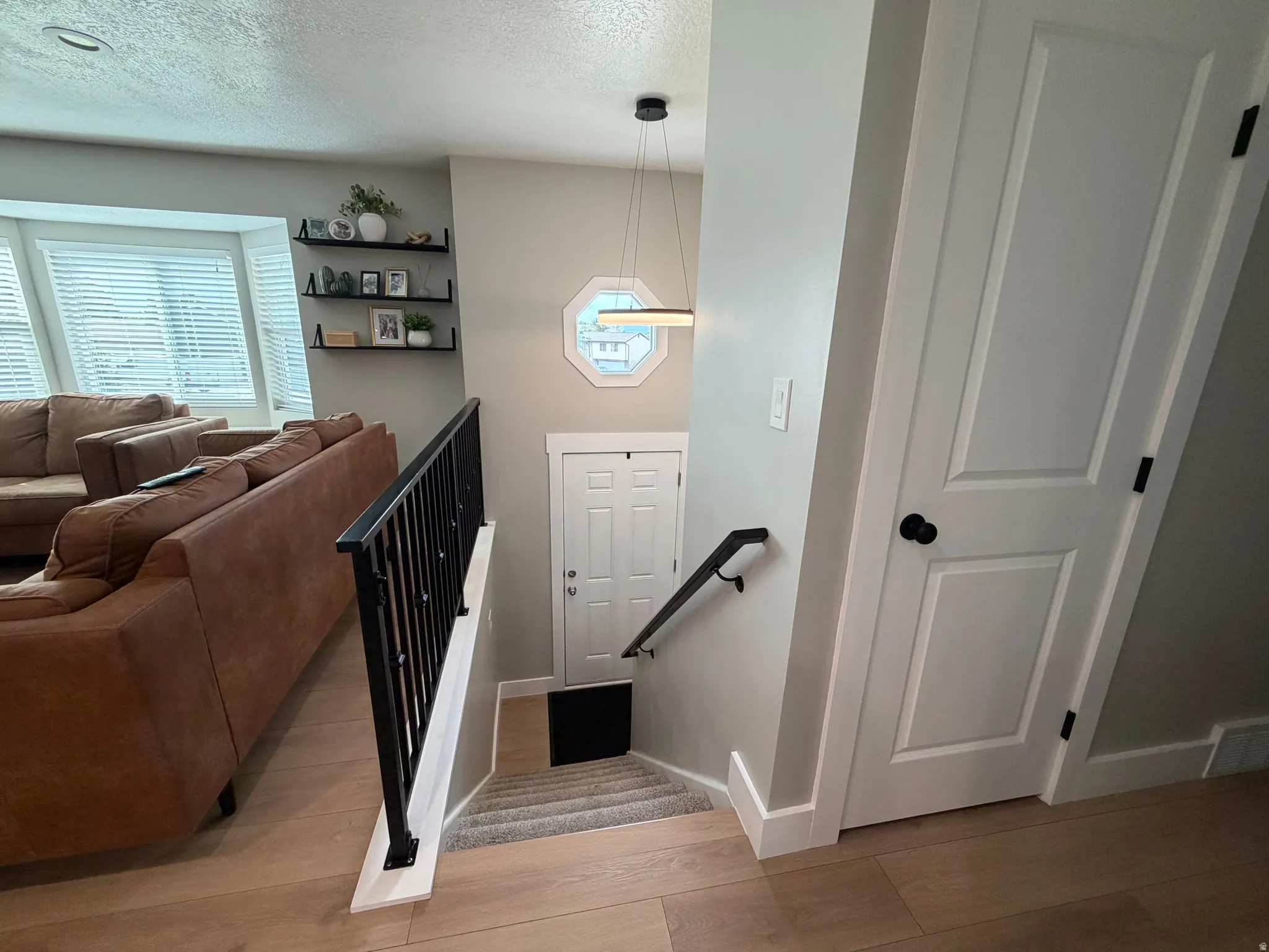 Open-concept living space with light wood-finish flooring