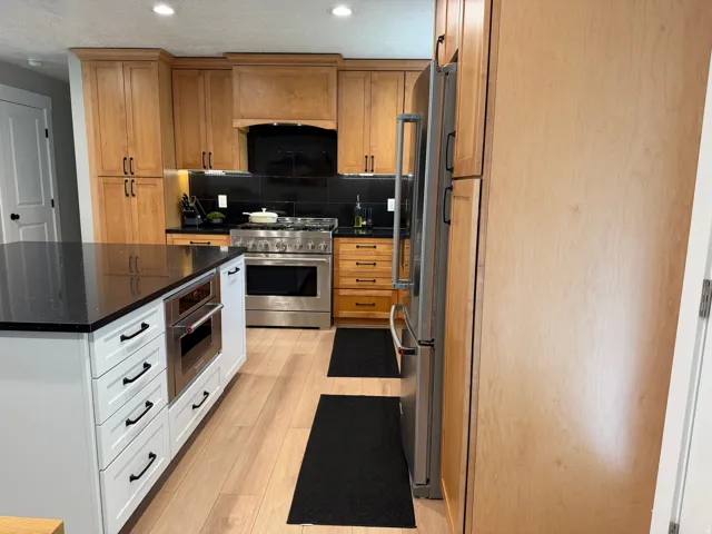 Modern kitchen featuring light wood cabinetry and a large center island with white shaker-style drawers