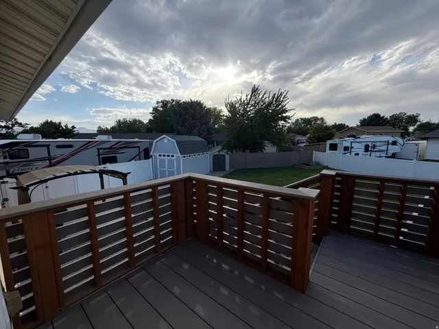 Expansive deck featuring composite decking and horizontal wooden railings