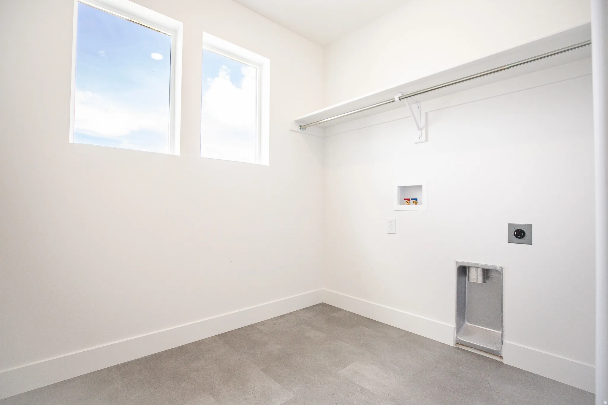 Full-size laundry room with natural light and washer/dryer hookups.