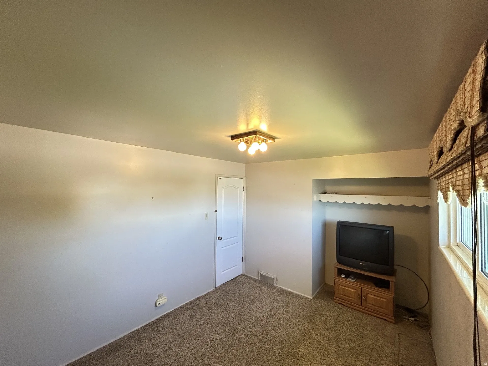 3rd Bedroom, Television Room or Office carpeted room with a ceiling-mounted light fixture, white walls, and a built-in alcove/closet.