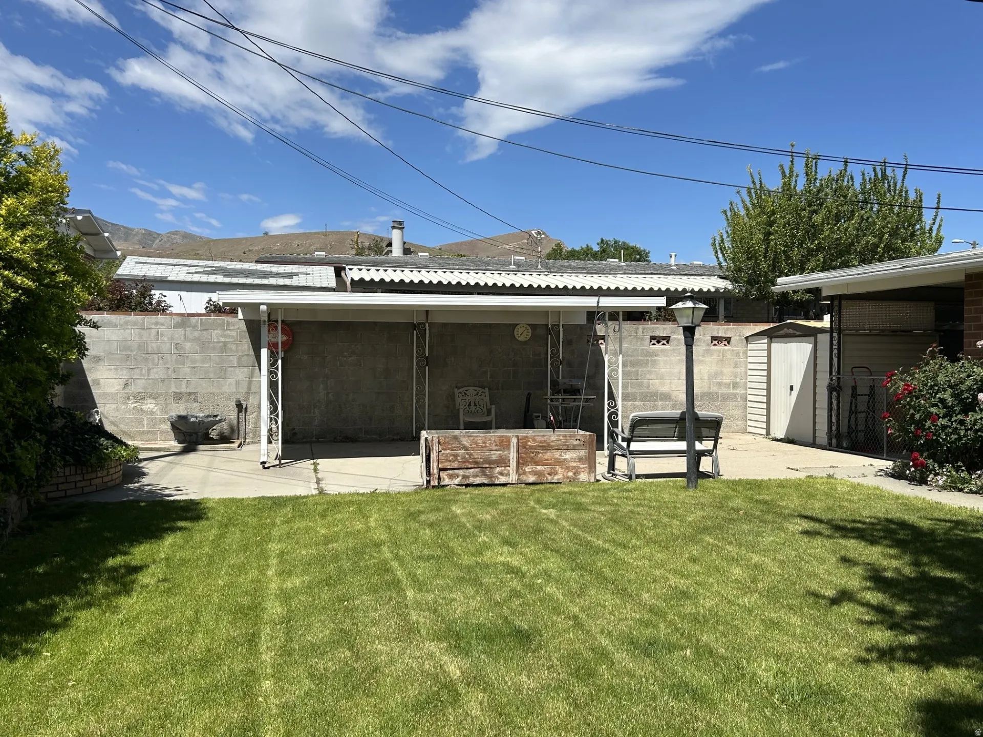 Private concrete patio featuring a covered awning